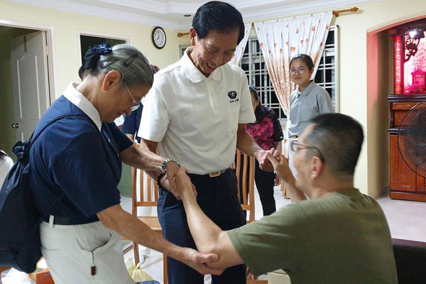 Medical Volunteers Help a Stroke Patient Stand Up on His Own